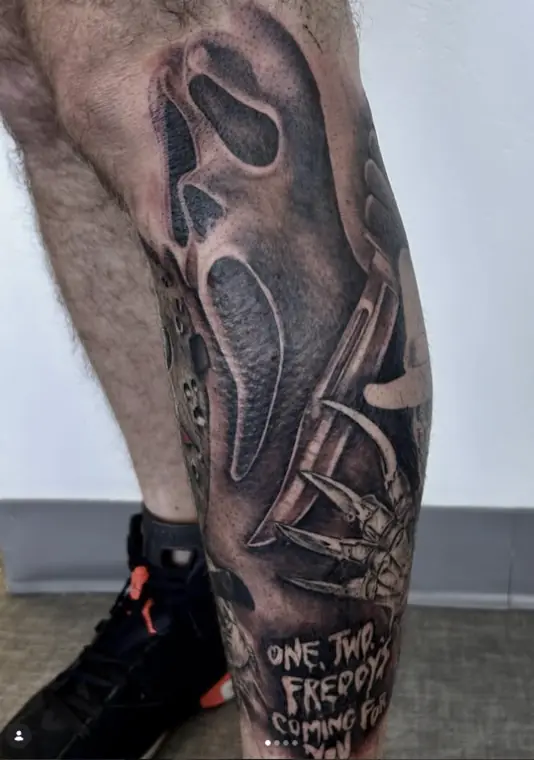 A horror leg sleeve with a masked figure and a clawed glove, black and grey.